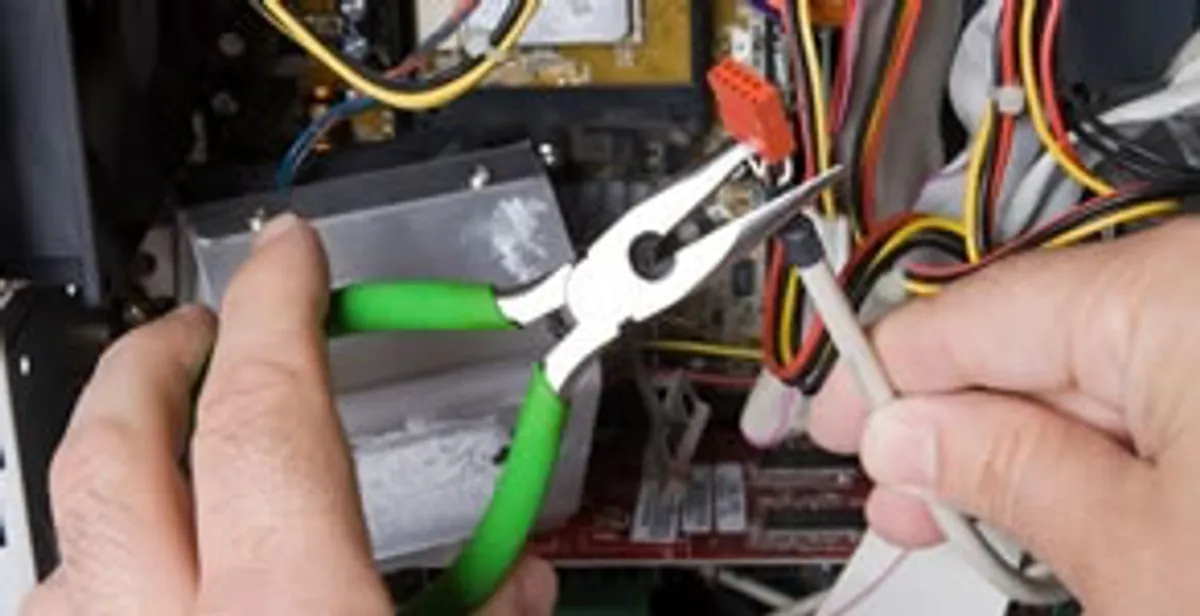 Licensed electrical contractor performing electrical repair with tools in Huntertown, IN