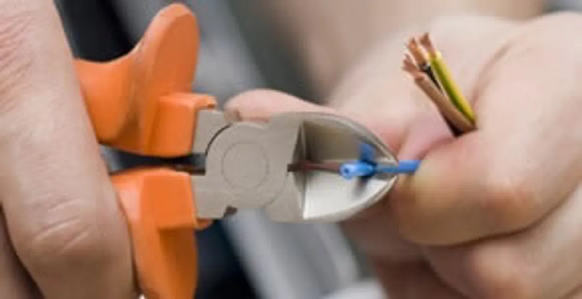 professional electrical services showing precise wire cutting by licensed electricians in Fort Wayne, IN
